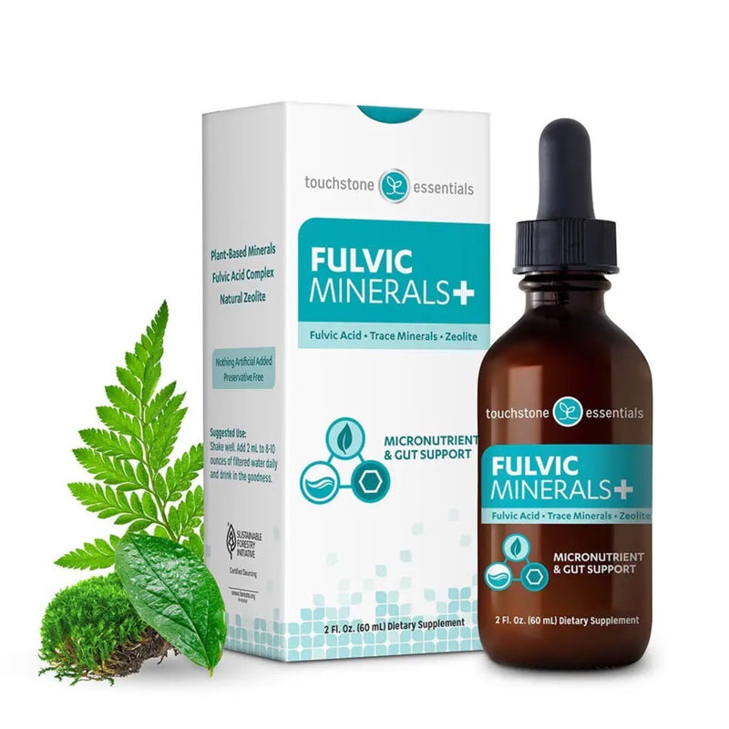 Fulvic Minerals supplement bottle and packaging with green leaves on a white background
