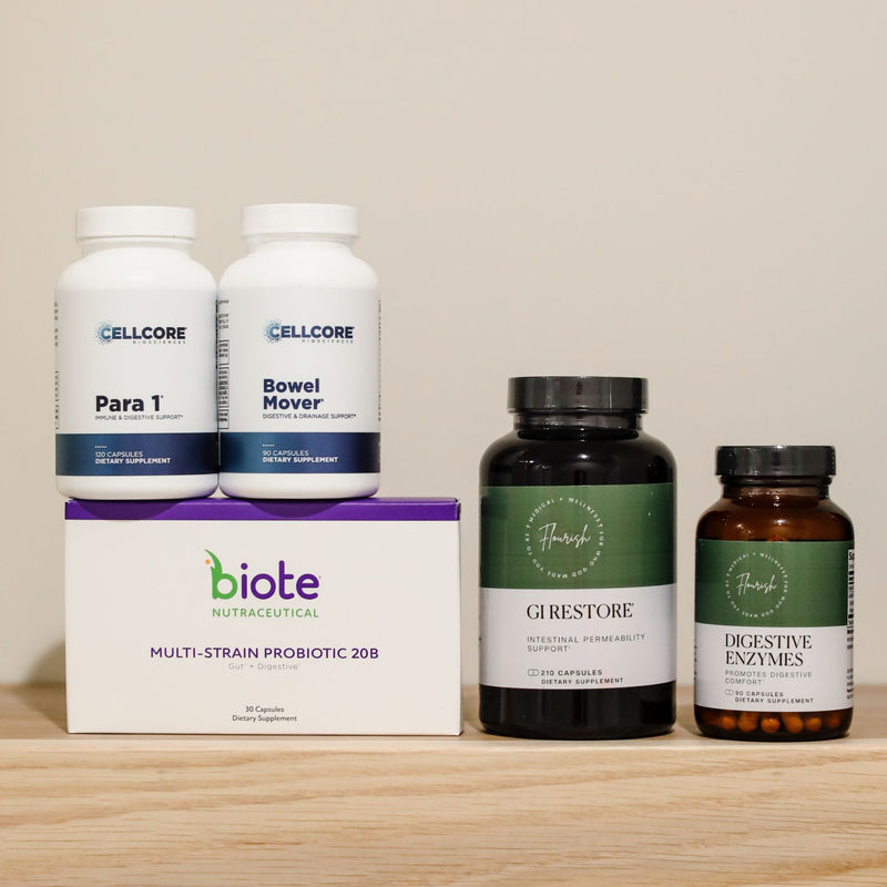 A dietary supplement bundle featuring two white Cellcore bottles, a white biote box, a dark green biote GRestore bottle, and an amber biote Digestive Enzymes bottle, arranged on a light wood surface against a beige background.