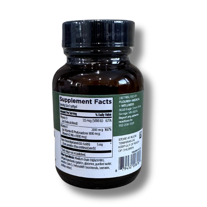 An amber brown supplement bottle with a black ribbed cap, showing the back of the label with supplement facts and a barcode on a white background.
