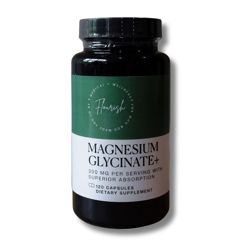 A black plastic bottle of Flavour of the Day Magnesium Glycinate+ dietary supplement, featuring a green and white label, on a white background.