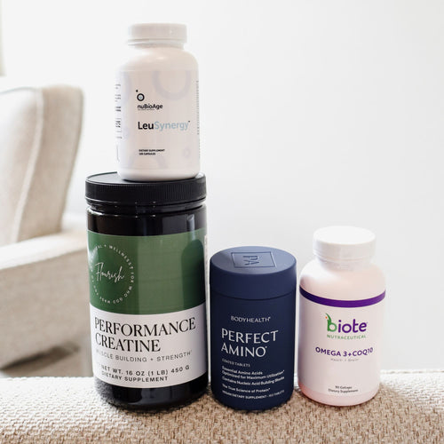 Four dietary supplement bottles and jars arranged on a beige textured surface against a white wall. The products include LeuSynergy by NutriAge on top, Performance Creatine by Fresh Labs underneath it, Perfect Amino by Bodyhealth in a dark blue jar, and Omega 3+CoQ by Biote in a pinkish-white bottle.
