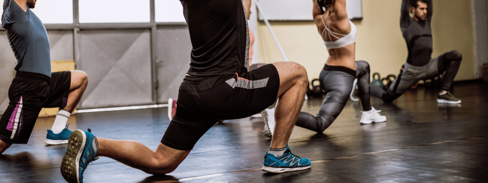 Group of people exercising in a gym setting