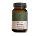 A bottle of Flavour of the Day Thyro Restore dietary supplement, containing 80 capsules. The product is in an amber glass bottle with a dark green and beige label and a black cap, shown on a white background with a soft shadow.